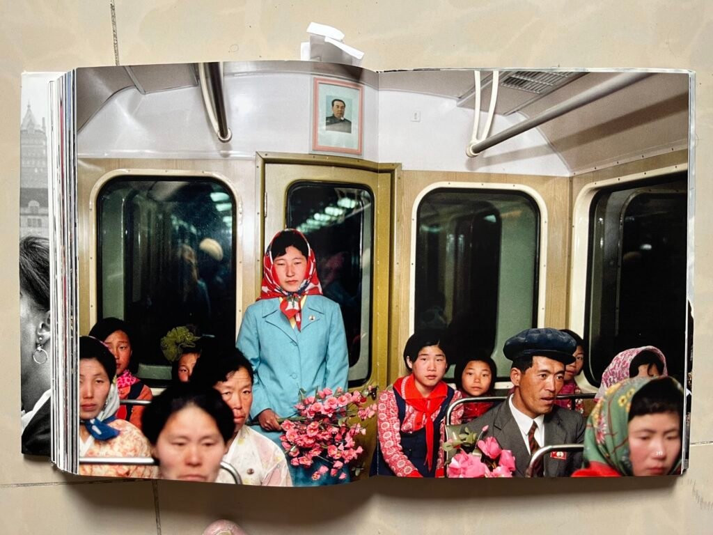 North Korea, subway, North Koreans, commuters, men wome, reflection of hiroji kubato, color North Korea, flowers, nicely dressed people