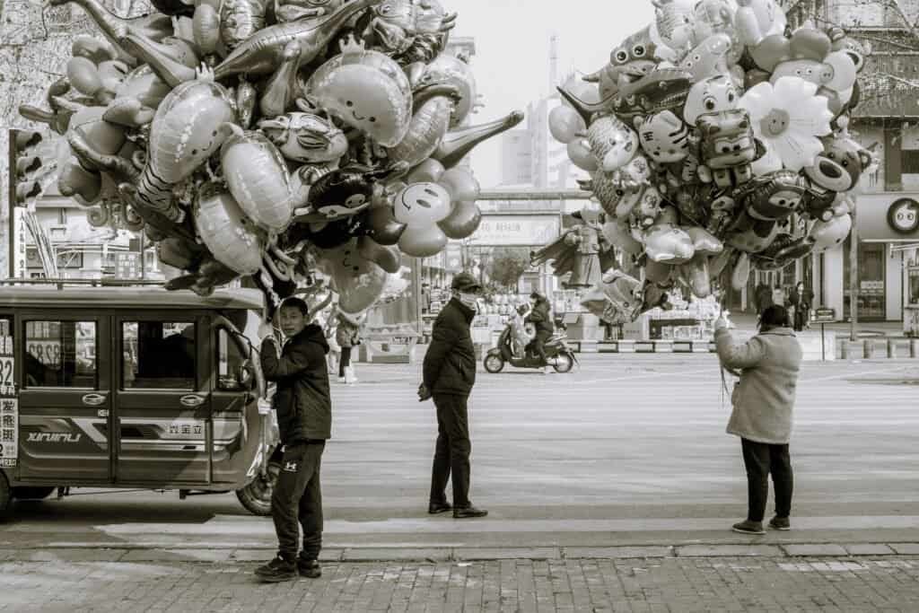 Lianyungang, jiangsu, china, man, woman,balloon, sitting, street, black and white, street, bike,