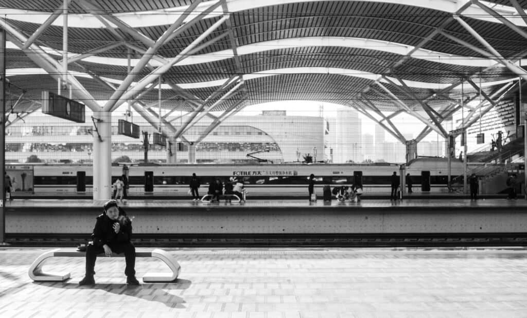 Countryside, black and white, china, train window platform, city, buildings, man smoking