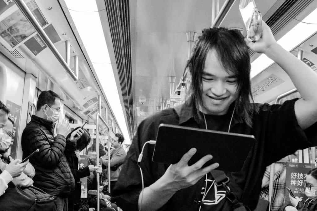 A man on iPad Taken on the fujifilm x-t30 7artisans f1.2 35mm pre focused black and white china shenzhen