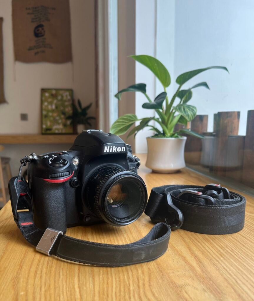 nikon d600 on table with peak design straps