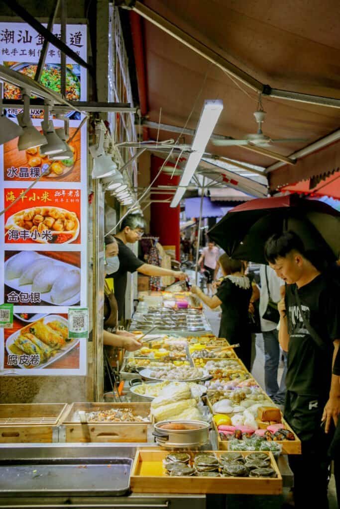 In dongmen Shenzhen china taken on Cannon 6d Mark 1 vendors selling food shops and signs all around daytime