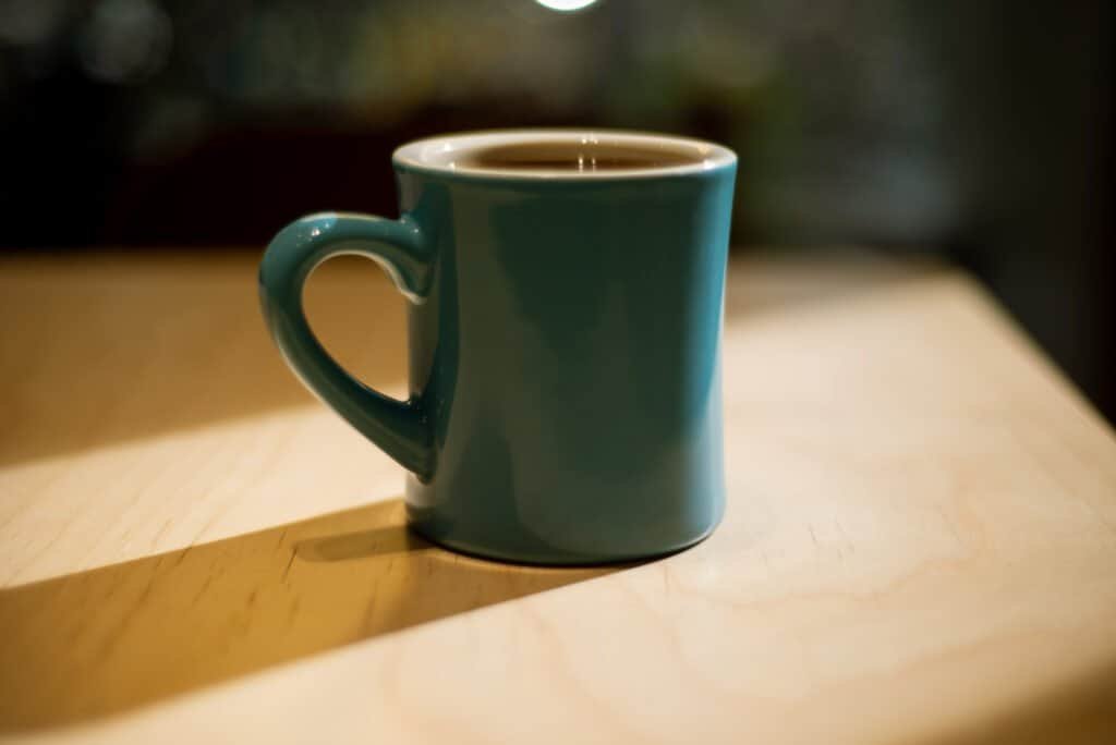 Coffee mug in Shenzhen close up shadow setting light china coffee table pine colour Nikon d600