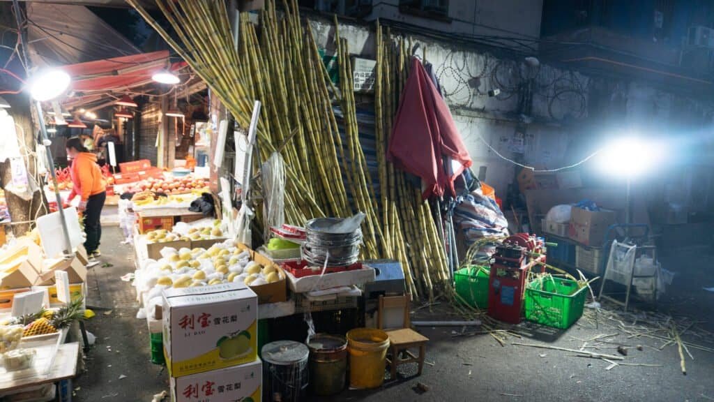 Vibrant night market scene with fresh fruits and bamboo stalks Chengdu china