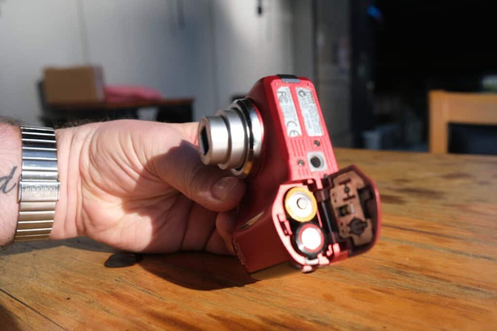 Nikon Coolpix 3200 battery view Wooden table hands sunshine chair