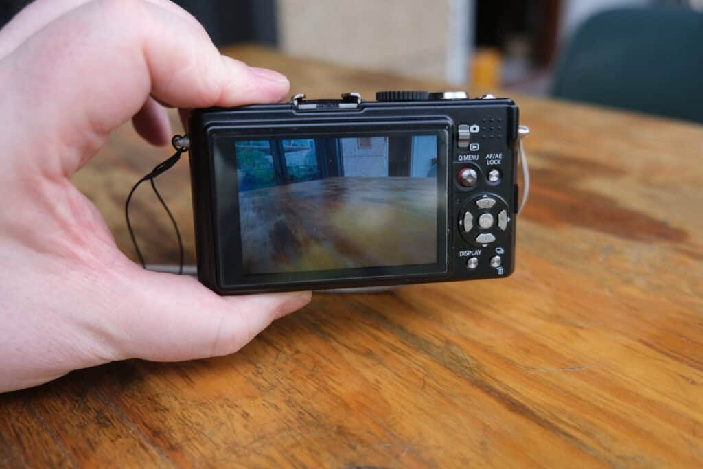 Panasonic LUMiX DMC LX3 in hand table strap back screen readable in daylight