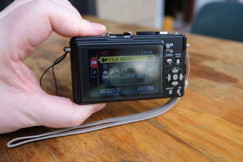 Panasonic LUMiX DMC LX3 in hand table strap back screen menu readable in daylight