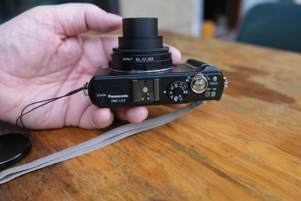 Panasonic LUMiX DMC LX3 in hand table strap from top fully extended
