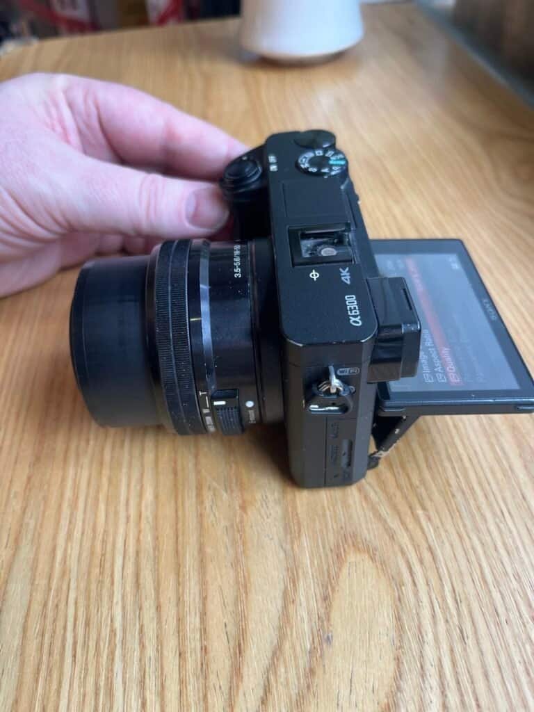 Camera with lens on wooden table close-up shot
