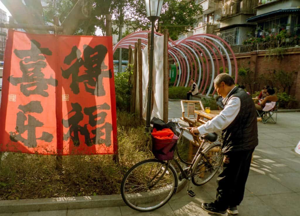 Old man parks bike Chengdu china daylight