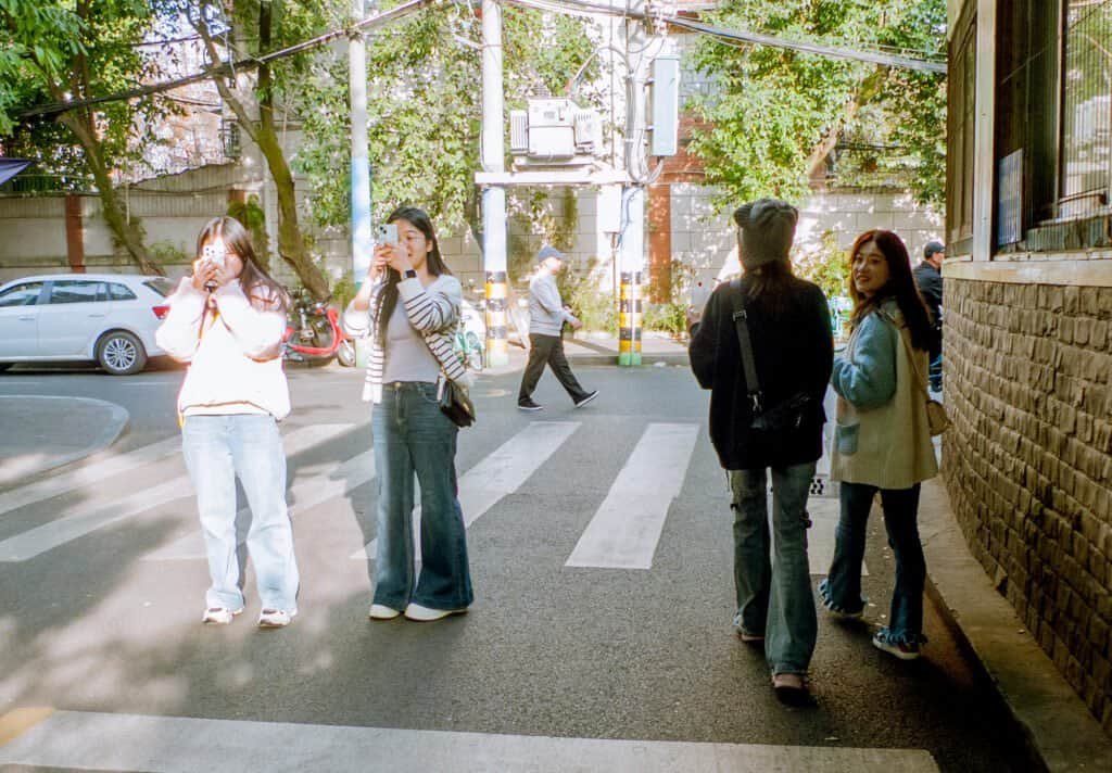 Girls in photo taking phots street Chengdu china girls people phones