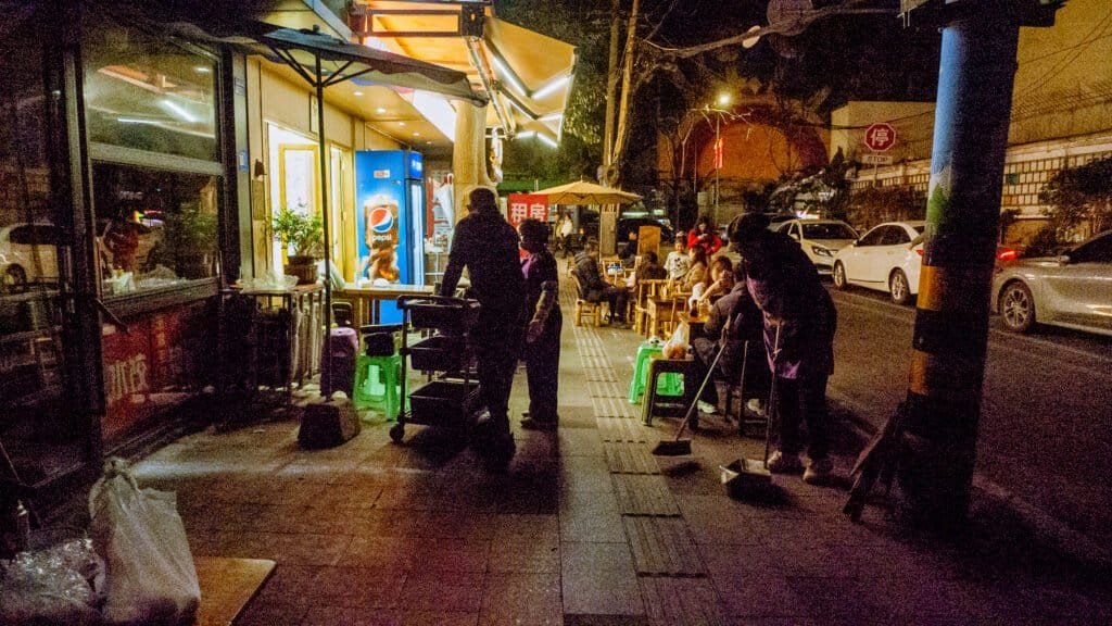 night Chengdu public table street old man woman people china tables chairs eating